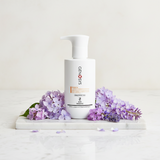 GENEOSYS product bottle with lavender flowers on a light background
