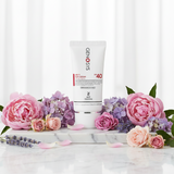 Genosys Multi Sun SPF40 skincare cream with pink flowers on a marble surface